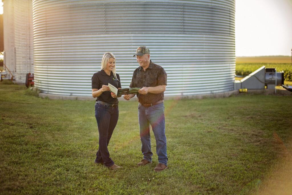 AgriFinancial lender talks with CGB farmer on farm to discuss grain bin leasing options